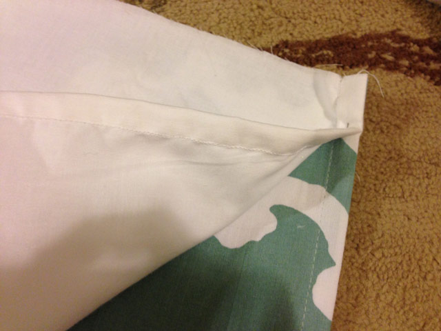 shower curtain and white panel pinned together for sewing