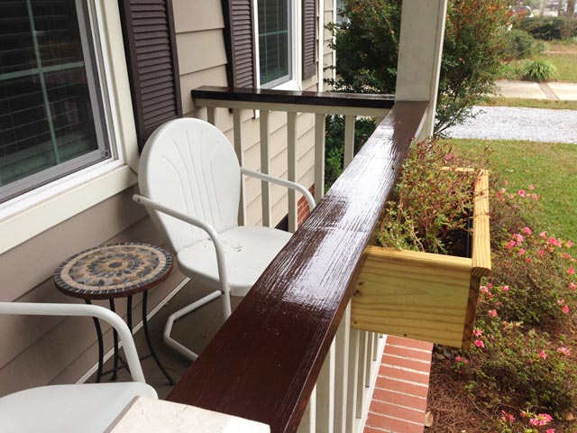 wood handrails after 3 coats of varnish with retro chair on front porch