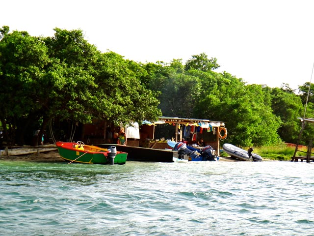 boats on shore at remote island roger's grenada hog island