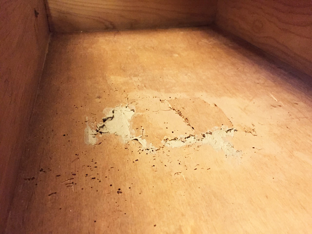 wood filler in void in bottom of wood dresser drawer