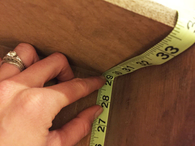tape measure and hand at 29 inches inside of wood drawer